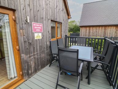 A decking area with a table and chairs at James Ville Marina Lodge 14 in Brigg