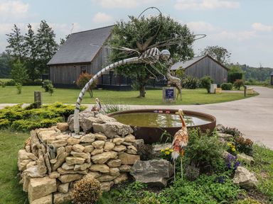 A garden with a sculpture and pond at James Ville Marina Lodge 21 in Brigg