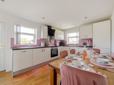 A kitchen with a dining table and chairs at James Ville Marina Lodge 23, Brigg