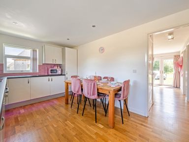 A kitchen with a dining table and chairs at James Ville Marina Lodge 23 in Brigg