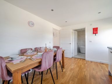 A dining room with a table set for a meal at James Ville Marina Lodge 23 in Brigg