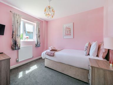 A bedroom with a bed and television at James Ville Marina Lodge 23 in Brigg