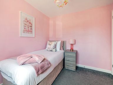 A bedroom with a single bed and nightstand at James Ville Marina Lodge 23 in Brigg