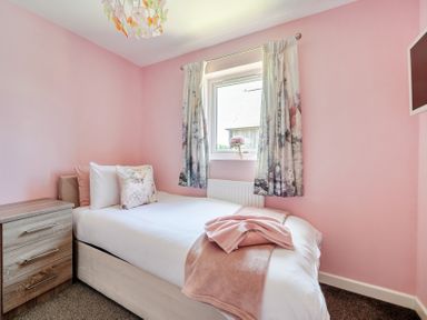A bedroom with a bed and nightstand at James Ville Marina Lodge 23 in Brigg