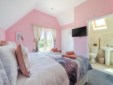 A bedroom with a bed and television at James Ville Marina Lodge 23 in Brigg