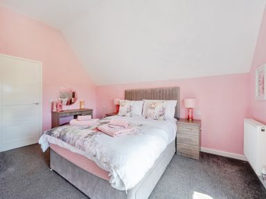 A bedroom with a bed and nightstand at James Ville Marina Lodge 23 in Brigg
