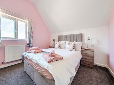 A bedroom with a bed and bedside table at James Ville Marina Lodge 23 in Brigg