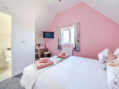 A bedroom with a bed and television at James Ville Marina Lodge 23 in Brigg