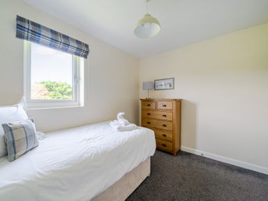 A bedroom with a bed and dresser at James Ville Marina Lodge 10 in Brigg