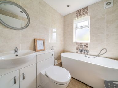 A bathroom with a bathtub, toilet, sink, and mirror at James Ville Marina Lodge 10 in Brigg