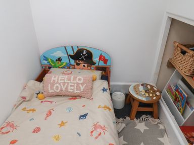 A bedroom with a bed and a small stool at Apartment 3 in Scarborough