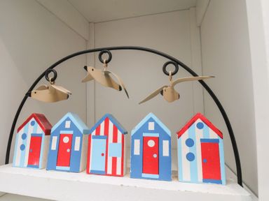 A decoration with five wooden beach houses and birds at Apartment 3 Scarborough
