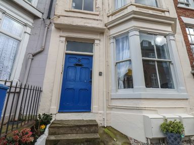 A front door with a blue color and steps at Apartment 3 in Scarborough
