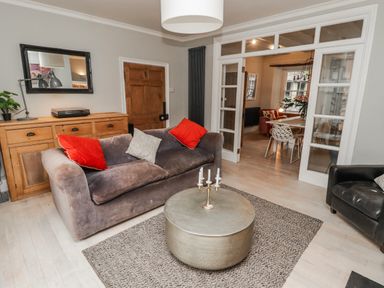 A living room with a sofa and coffee table at The Secret Garden in Narberth