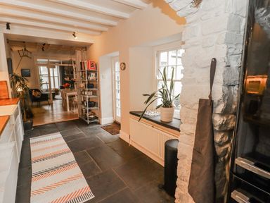 A kitchen with shelves and a plant at The Secret Garden in Narberth