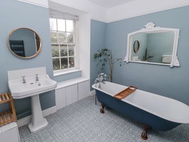 A bathroom with a bathtub and sink at The Secret Garden in Narberth