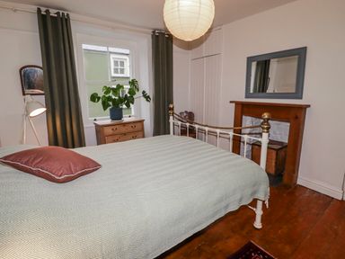 A bedroom with a bed and lamp at The Secret Garden in Narberth