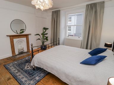 A bedroom with a bed and plant at The Secret Garden in Narberth