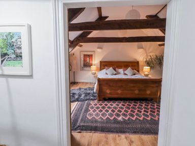 A bedroom with a bed and decorative elements at The Secret Garden in Narberth