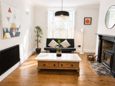 A living room with a coffee table and sofa at The Secret Garden in Narberth