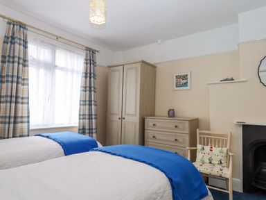 A bedroom with two beds and furniture at 16 Elmbank Gardens in Paignton