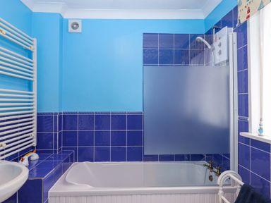A bathroom with a bathtub and shower at 16 Elmbank Gardens in Paignton