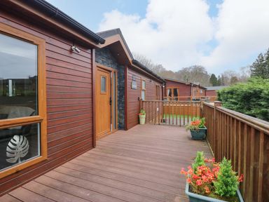 An outdoor deck area with planters at Waters Edge Lodge Windermere
