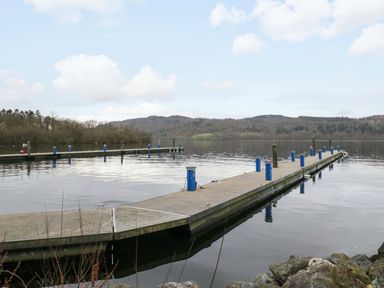 A dock with piers on water at Waters Edge Lodge Windermere