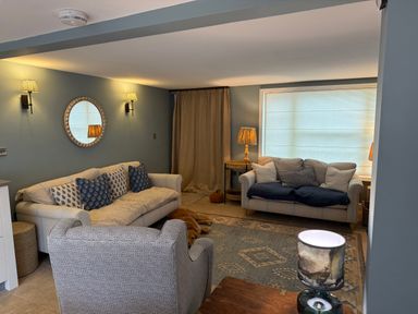 A living room with sofas and a coffee table at York Cottage in Southwold