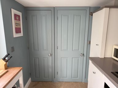 Two doors and a kitchen counter in a kitchen at York Cottage in Southwold