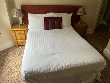 A bedroom with a bed and bedside tables at Picton House near St Clears