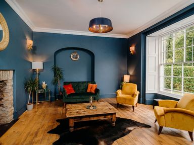 A living room with seating and a coffee table at Picton House near St Clears
