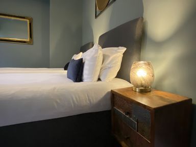 A bedroom with a bed and nightstand at Picton House near St Clears