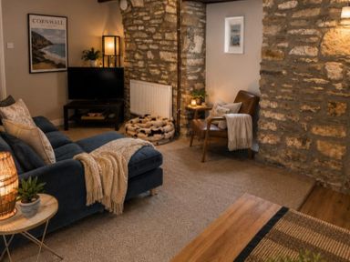 A living room with a television and sofa at Coach House in St Clears