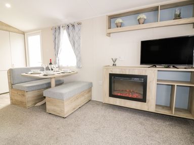 A dining room with a table and benches at Barney's Retreat in Newquay
