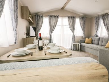 A living room with a dining table and sofa at Barney's Retreat in Newquay