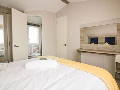 A bedroom with a bed and wardrobe at Barney's Retreat in Newquay