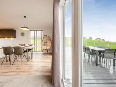 A dining room with a table and chairs at Sonnet 2 Spa Roof Terrace (Pet) Carmarthen