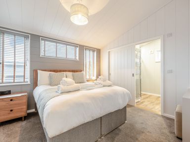 A bedroom with a bed and towels on it at Sonnet 3 Spa Carmarthen