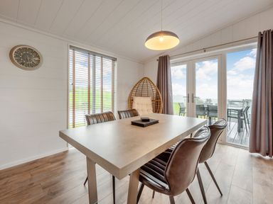 A dining room with a table and chairs at Sonnet 3 Spa in Carmarthen