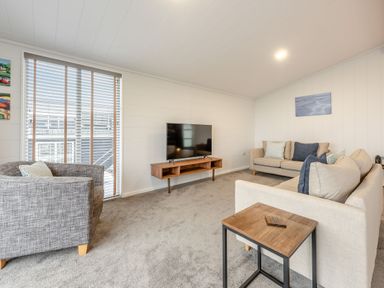 A living room with a television and seating at Sonnet 3 Spa in Carmarthen