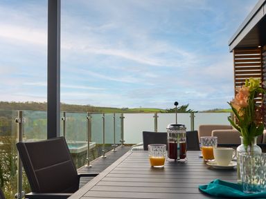 An outdoor seating area with a table set for drinks at Wilde Spa (Pet) Carmarthen