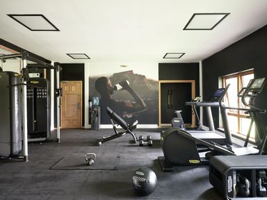 A gym with various exercise equipment at Wansfell (Pet) in Penrith