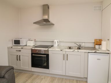 A kitchenette with appliances and basic fixtures at Radharc an Hook @ Estuary Bliss