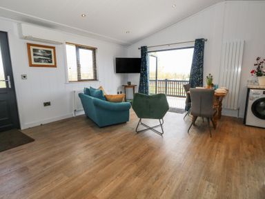 A living room with a sofa and table at Grass Roots