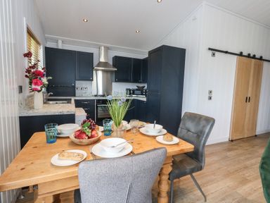 A kitchen with a dining table and chairs at Grass Roots