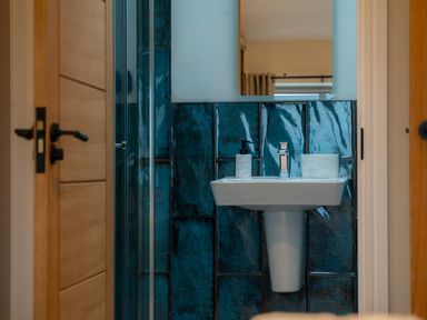 A bathroom featuring a sink and a shower at The Joiners Cottage in Birling near Warkworth