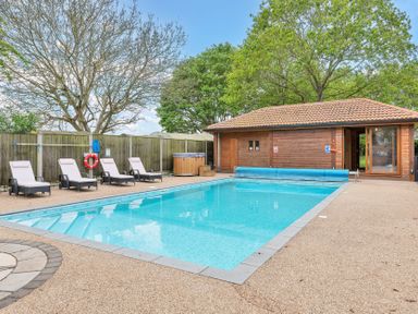 An outdoor area with a swimming pool and lounge chairs at Oldfields