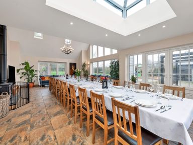 A dining room with a long table and chairs at Oldfields