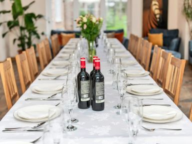 A dining room with a long table set for a meal at Oldfields